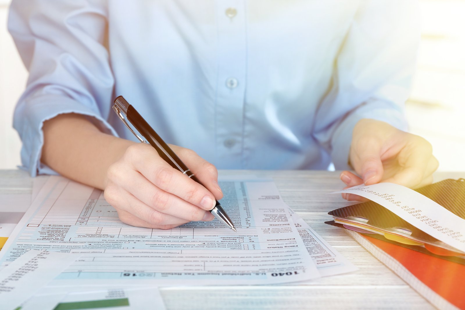 Professional preparing tax documents with a calculator